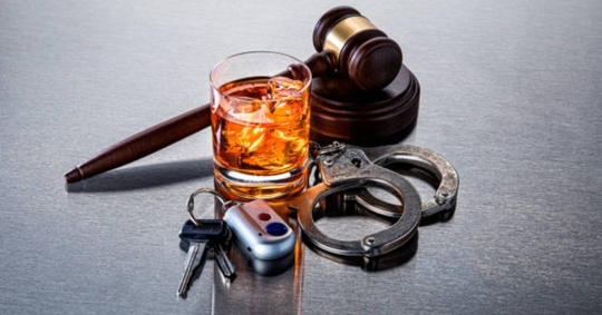 alcoholic drink and handcuffs